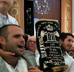 Holding one of 11 sacred Torah scrolls in a Tel Aviv synagogue this morning on Simchat Torah