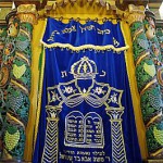 The Parokhet (embroidered curtain) can be either inside or outside the Aron Kodesh (Holy Ark).