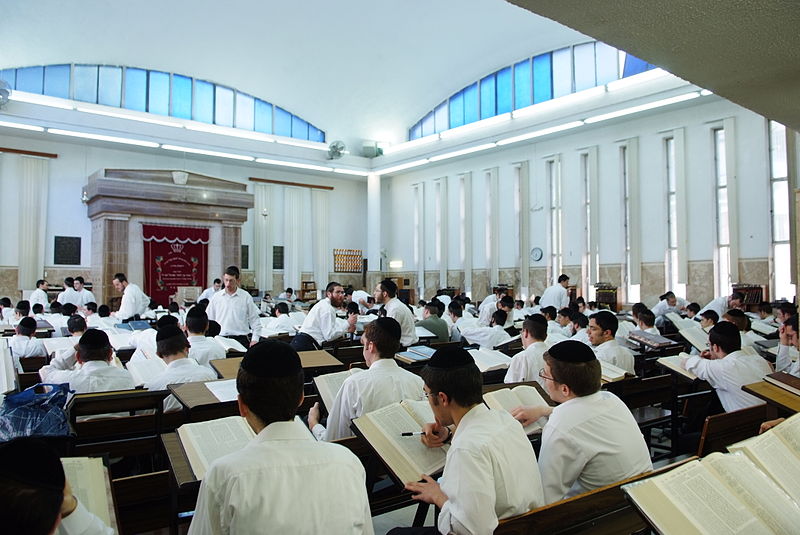 Jewish young men studying at a yeshiva, an Orthodox Jewish institution of learning.