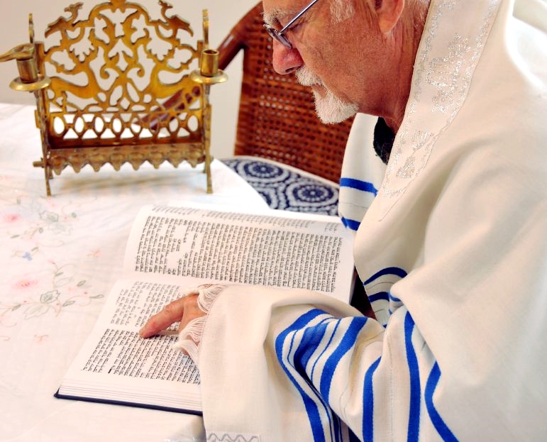 Jewish man-tallit-prayer shawl-Tanakh-Hebrew Scriptures-reading