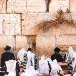 Jewish men pray at the Western Wall Plaza in Jerusalem