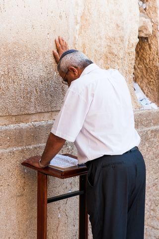 Kippah wearing man-prays-Western Wall