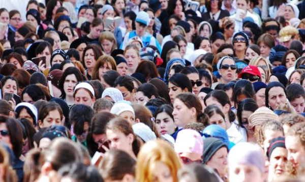 A large group of women pray at the Western Wall during Passover. 