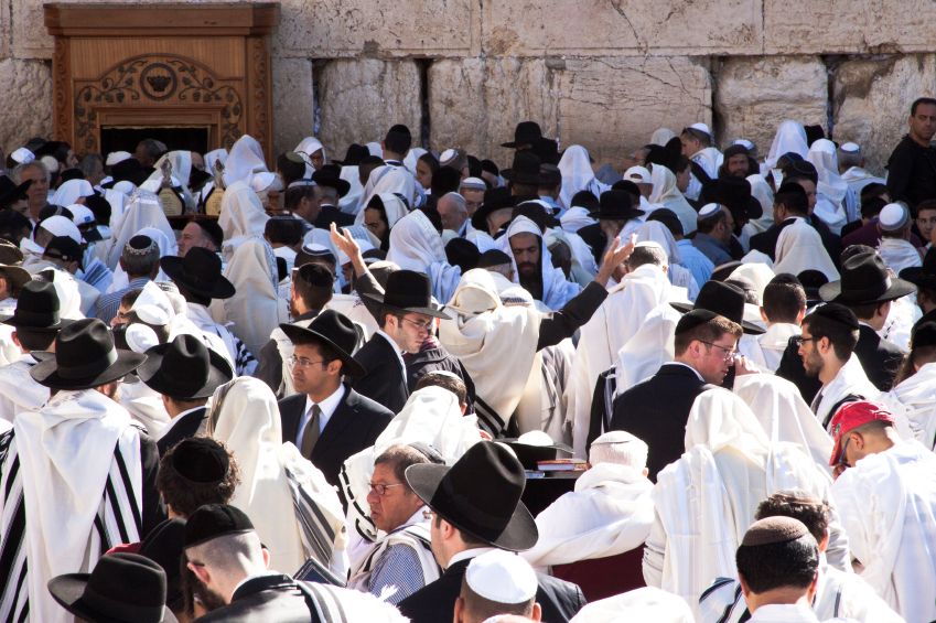 Jewish men gather for prayer at the Western Wall during Pesach.