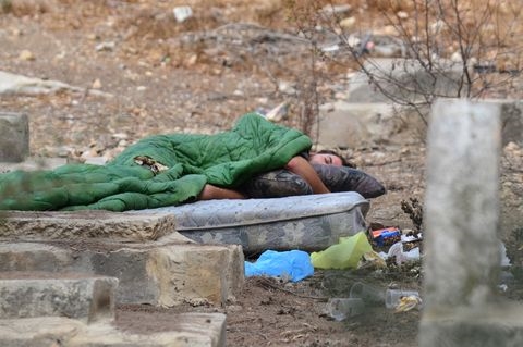 A homeless person in Israel sleeps in a cemetery on a mattress.  The month of Elul is a time to go out of our way to help the poor and needy.