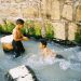 Israeli children, who have exited Hezekiah's Tunnel at the Pool of Siloam, play in the water that originates at the Gihon Spring.