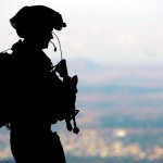 An IDF soldier stands guard at a military base in the Golan Heights.