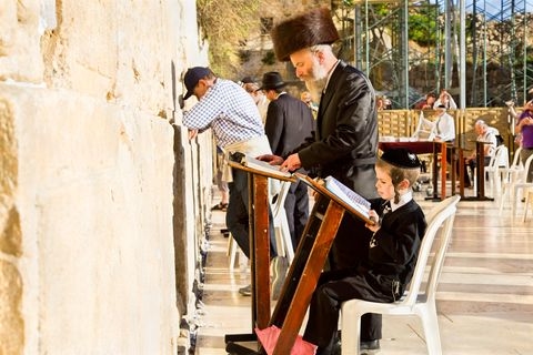 Jewish men and children pray at the Western (Wailing) Wall in the Old City of Jerusalem.