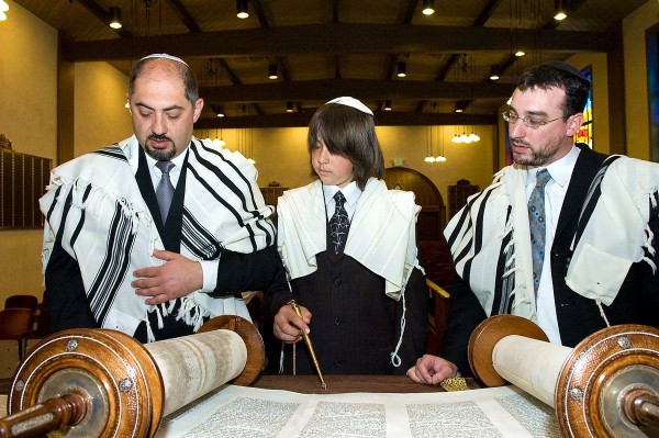 A 13-year-old Jewish boy reads from the Torah publicly for the first time.