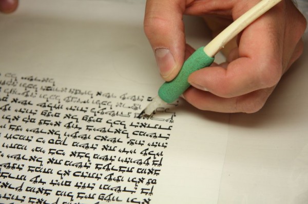 A Jewish scribe completes a Sefer Torah (Torah scroll).