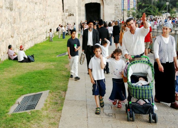 Jewish family walks ancient walls Jerusalem