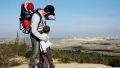 An Israeli father points out the family's hometown during a hike.