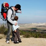 An Israeli father points out the family's hometown during a hike.