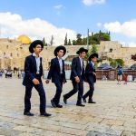 Ultra-Orthodox teens walk together at the Kotel (Western Wall) Plaza in Jerusalem.