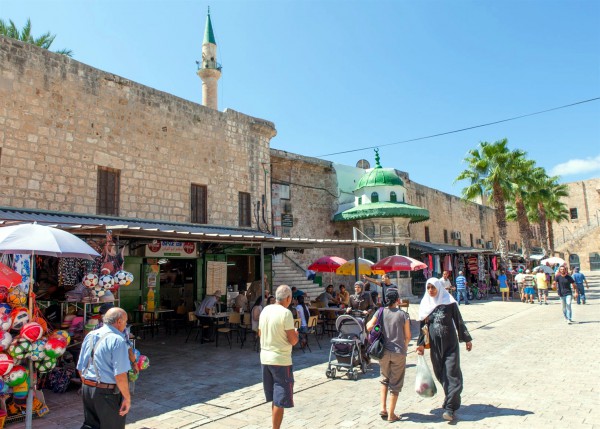 People of many ethnicities on a street in Acre, Israel