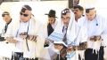 Jewish men wearing tallitot pray at the Western (Wailing) Wall in Jerusalem.