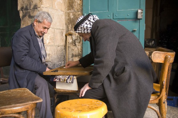 Two Arab men enjoy a game of Backgammon at a Jerusalem cafe.