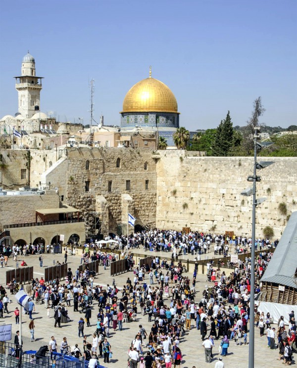 Jewish pilgrims visit the Western (Wailing) Wall during Passover. On the Temple Mount, the Muslim Dome of the Rock occupies the spot where the Holy of Holies once stood.