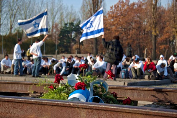 Flowers are placed on the train tracks that brought prisoners to Auschwitz.