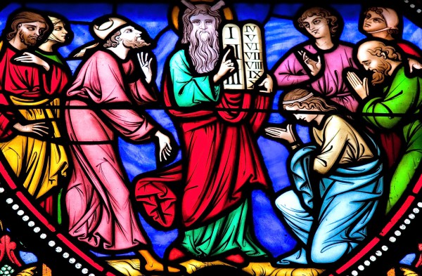 A stained-glass image of Moses and the Ten Commandments