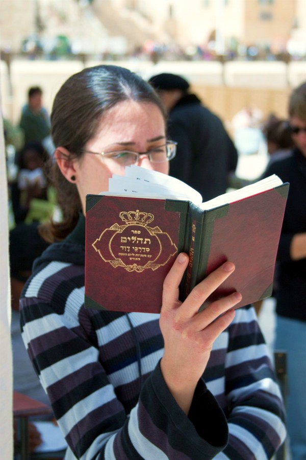 A Jewish woman reads the Psalms in Jerusalem.