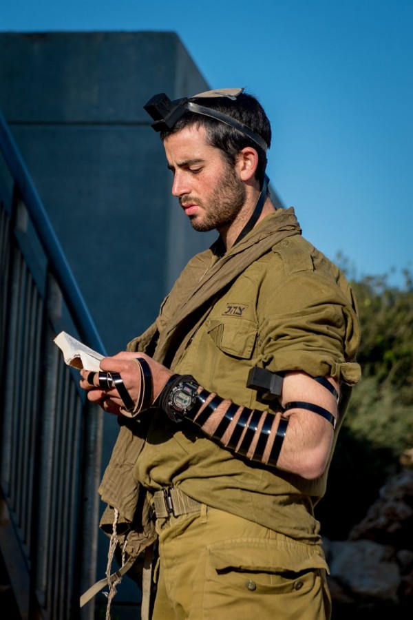 An Israeli soldier wearing tefillin (phylacteries) recites the morning prayers.