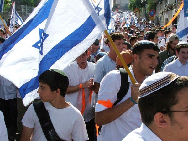 Israelis carry flags through the streets of Jerusalem.