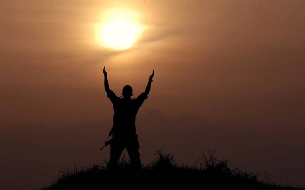 An Israeli soldier prays with upraised hands.