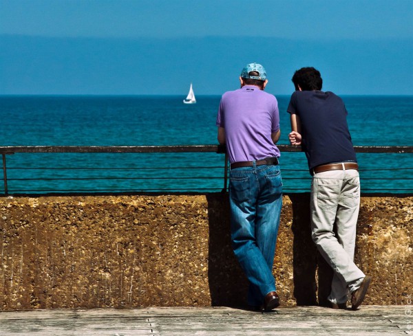 Friends converse by the sea in Israel.