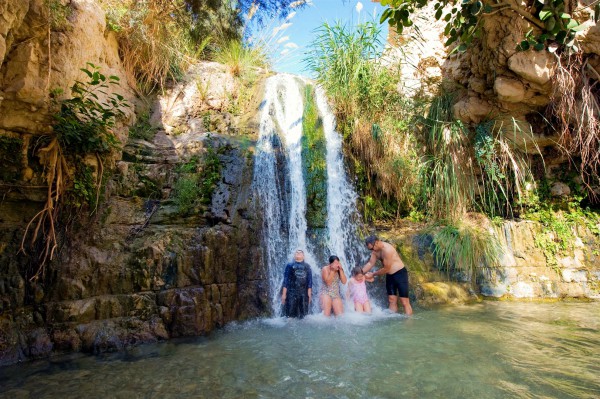 A father and his children refresh themselves at the Ein Gedi oasis, which is near Masada and the Dead Sea.