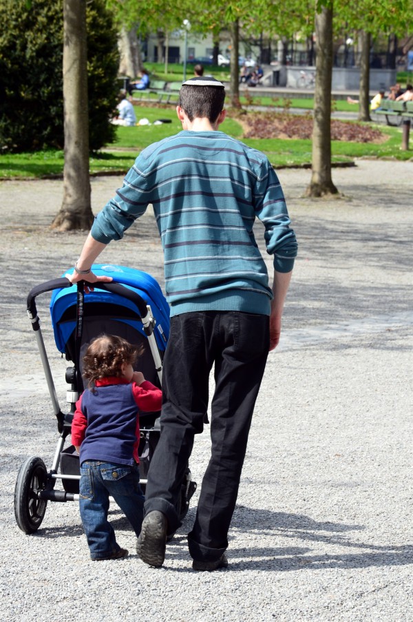 A Jewish father takes his child for a walk.