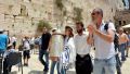 A 13-year-old Jewish teen carries the Torah scroll at the Western (Wailing) Wall in Jerusalem.