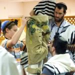 If the Torah scroll is not housed in a Torah tik (case), after the Torah reading, the Golel (roller) performs Gelila (rolling up). The Torah is then bound with a sash and covered with the Torah cover. The honor of being the Golel is sometimes given to a child under Bar Mitzvah age.