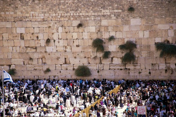 The men's (left) and women's (right) sections at the Western (Wailing) Wall in Jerusalem. Jewish people consider this site the holiest accessible site in Judaism. Above it is the Temple Mount, the holiest site in Judaism because on it the First and Second Temples once stood; however, it is not accessible for Jewish prayer.