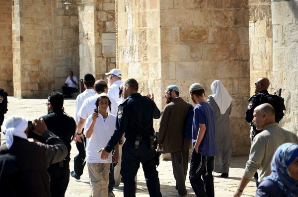 Police escort a small group of Jewish visitors on the Temple Mount.  (Photo by Michael Jones)