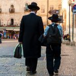 Father and son walk together in Jerusalem