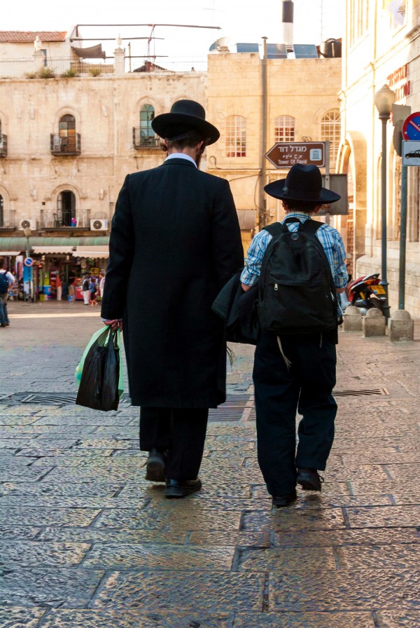 Father and son walk together in Jerusalem