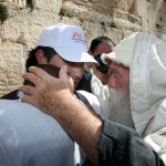 An observant Jewish Israeli blesses a father and son at the Western Wall (Israel Tourism photo by Sasson Tiram)