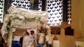 A Jewish man and woman exchange wedding vows under the chuppah. (Photo by Brett Lidder)