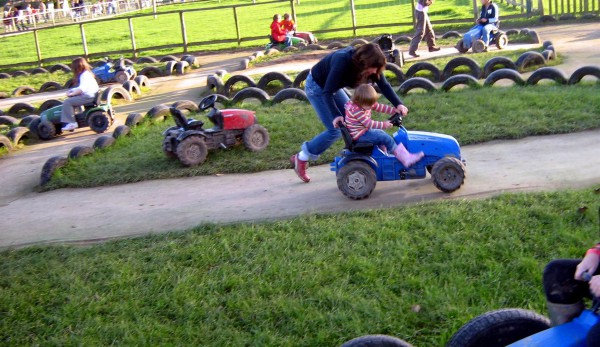 Mother pushes son in go cart