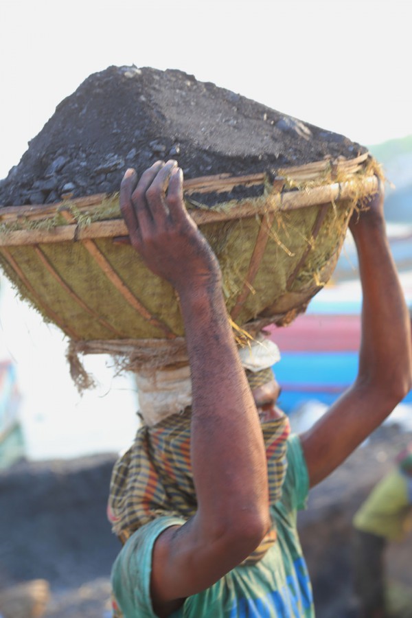 Man carrying coal on his head.